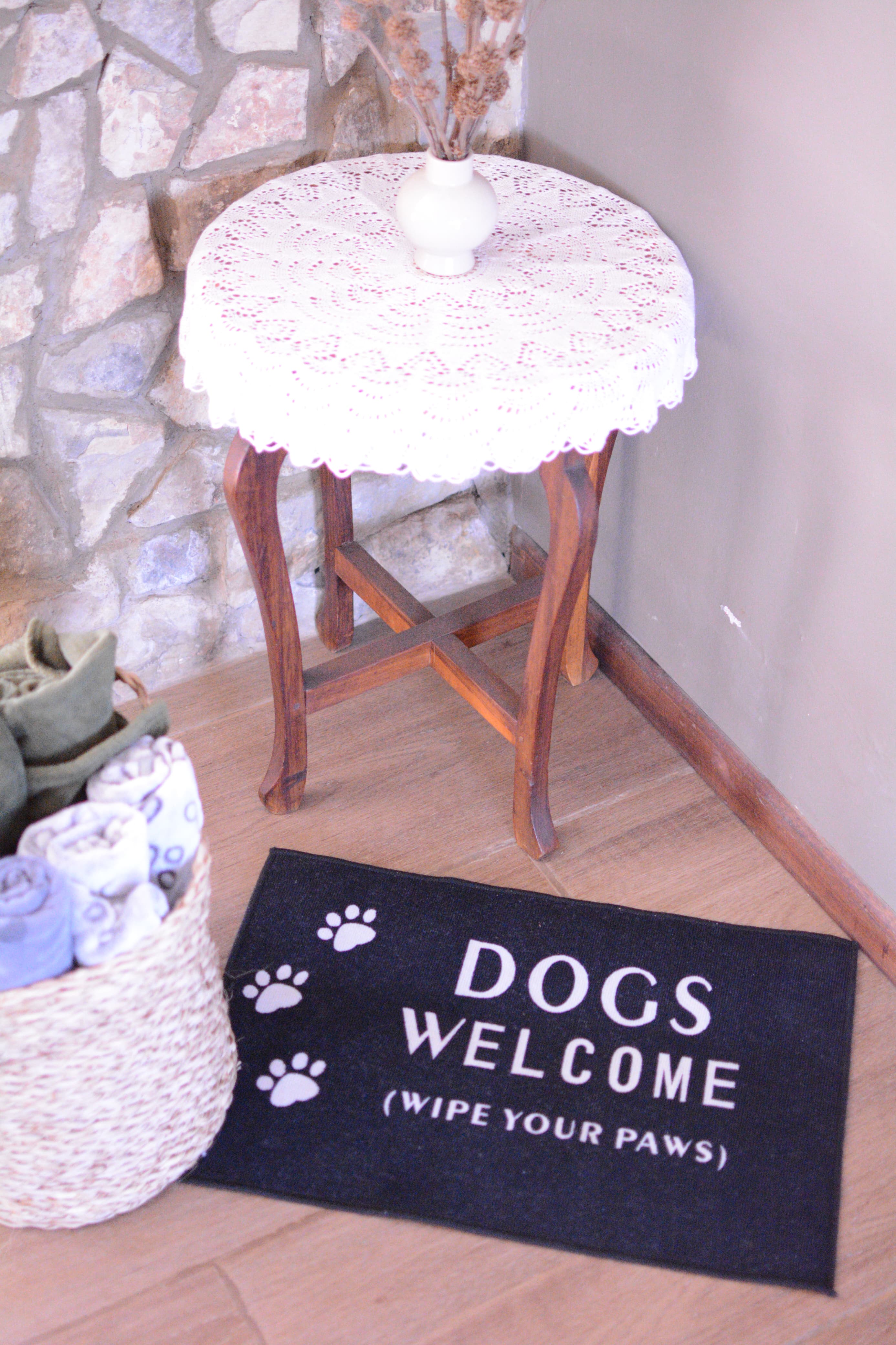 Dogs welcome mat and towel basket by the fireplace