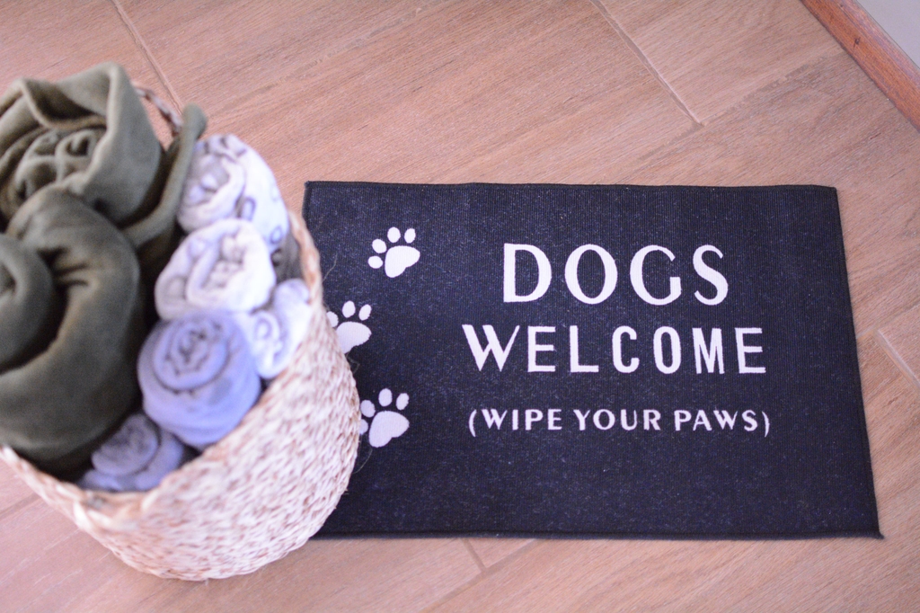 Dogs welcome mat at the farmhouse entrance
